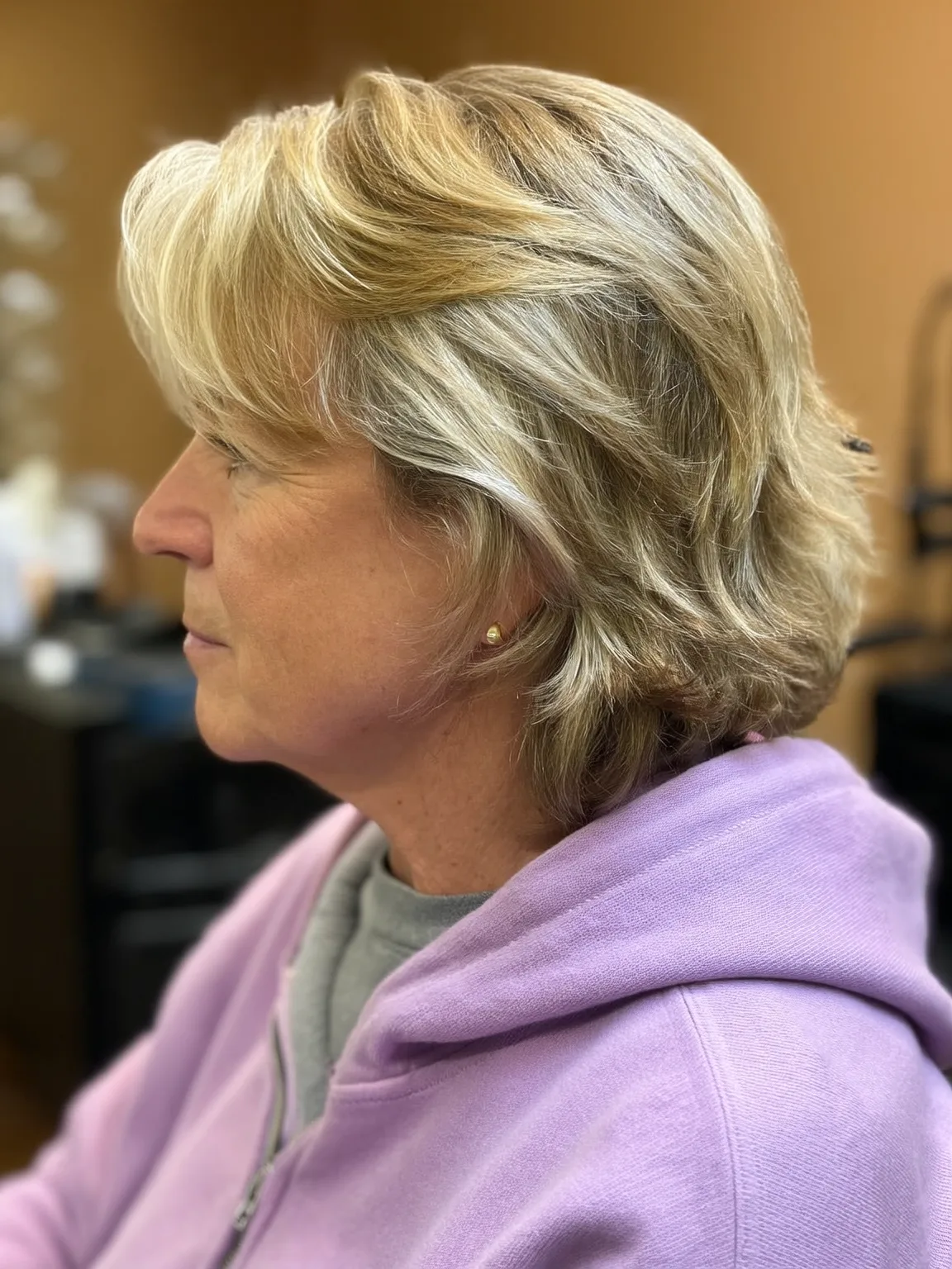 Sandy Blonde Wavy Feathered Layers with Side-Swept Bangs